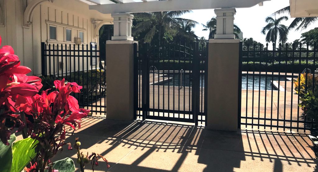 Photo of a black aluminum fence around a pool area